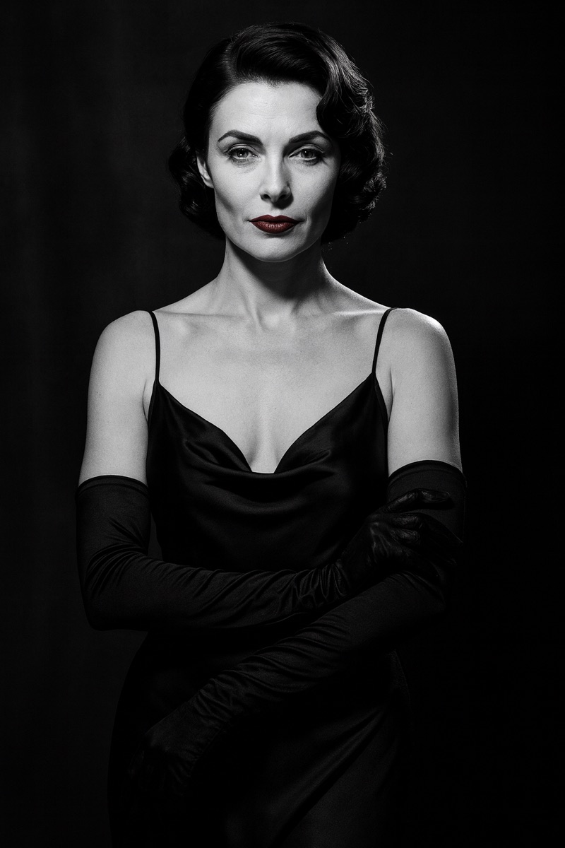 Miss Spent, the Accountability Dame, in a 1940s black-and-white noir portrait